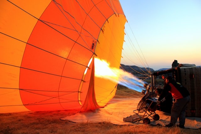 person heating up hot air balloon